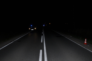 na zdjęciu znajduje się jezdnia na której stoi nieoznakowany radiowóz policji w nocy